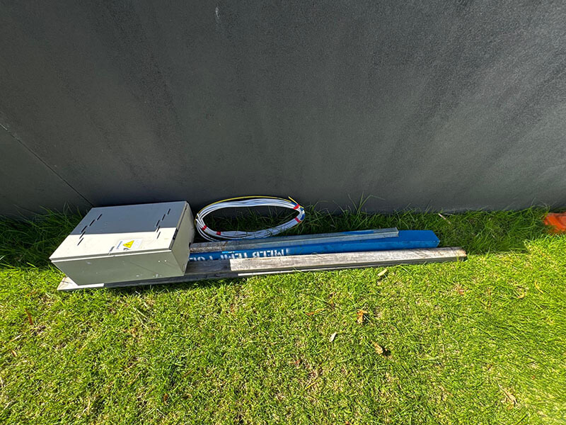 Temporary power pole setup with safety signage on a Melbourne construction site